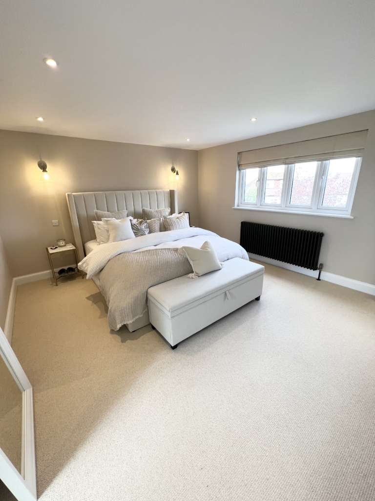 Second bedroom view inside a completed hip-to-gable loft conversion showing the gable window